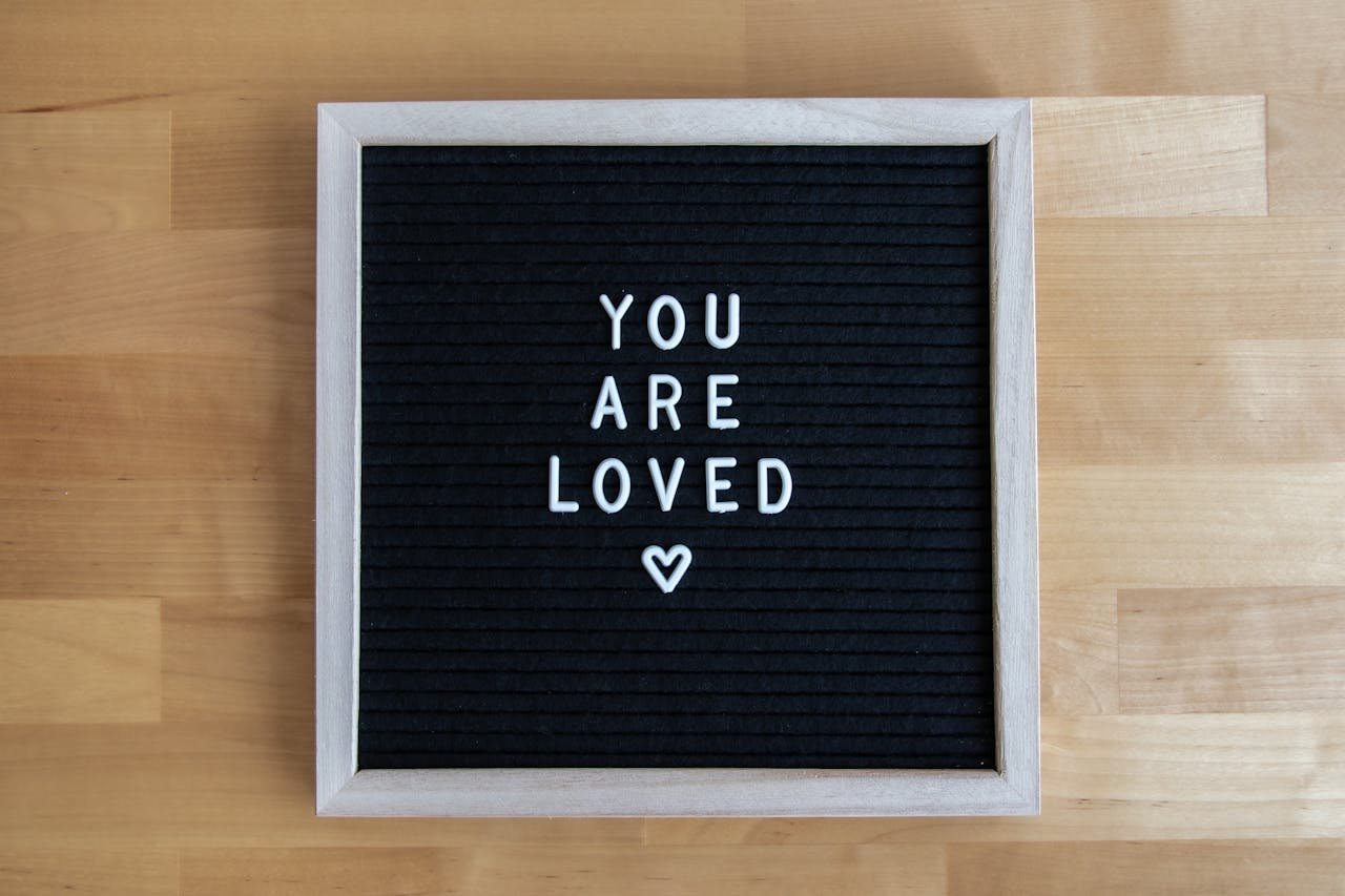 services-01 A black letter board with the motivational message 'You Are Loved' in white letters.